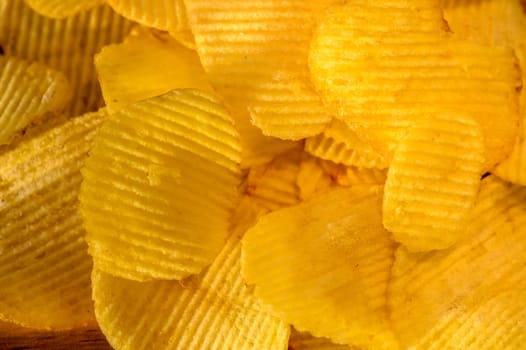 Close-up view of abundant crispy potato chips filling the frame for a textured background 2