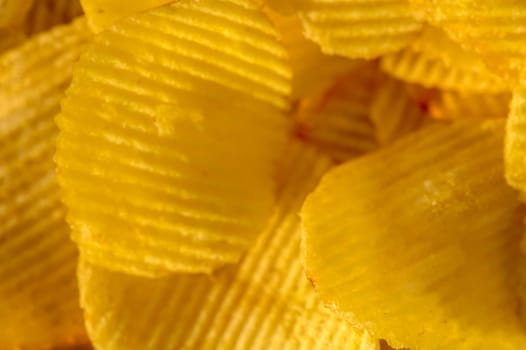 Close-up view of abundant crispy potato chips filling the frame for a textured background 1