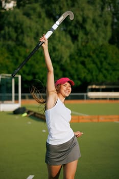girl hockey player plays field hockey on a sunny day, female hockey player celebrates a goal scored, victory in a field hockey match, active sport for girls