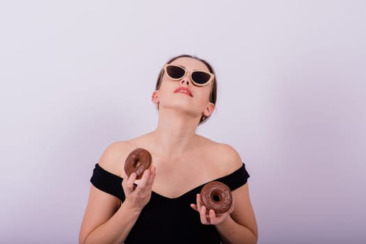 Close up young nice lady woman with slim body perfect skin nude top lingerie stand hold donut