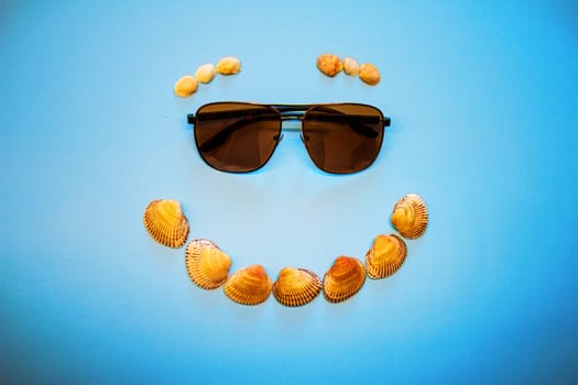 Orange smile - seashells with sunglasses. High quality photo