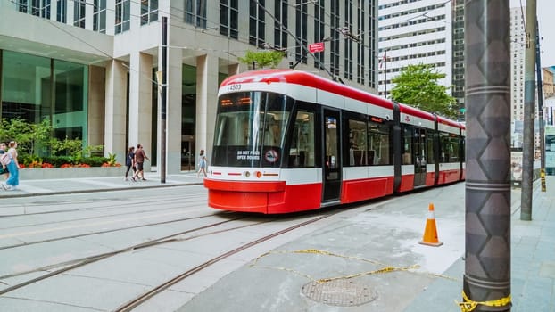 Street view of new TTC Bombardier-made streetcar in downtown Toronto's entertainment district. New Toronto Transit Commission tram on streets of Toronto. TORONTO, ON Canada - July 4, 2022..