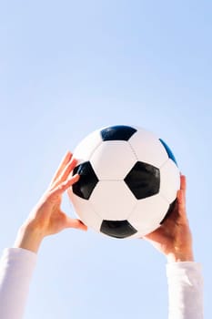 close up of hands holding a soccer ball, concept of football and sport, copy space for text