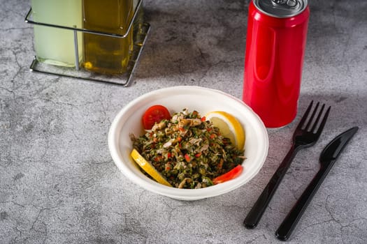 Healthy salad with capers, quinoa and walnuts on stone table