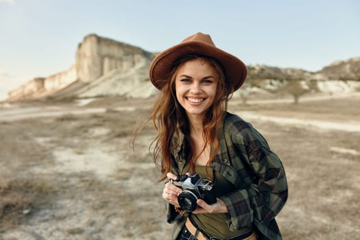 Happy woman with camera captures the beauty of the desert