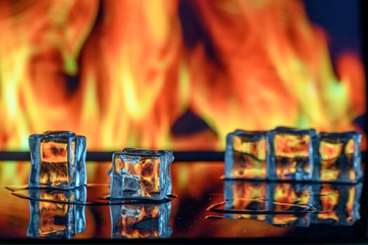 cubes of ice and fire on a water surface on an abstract background 2
