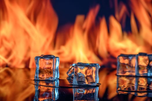 cubes of ice and fire on a water surface on an abstract background