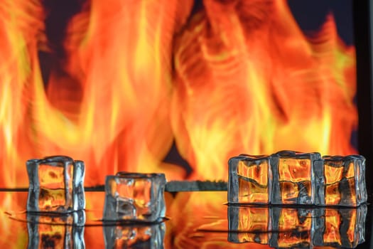 three ice cubes against the background of fire, fire and ice, place under the text 3