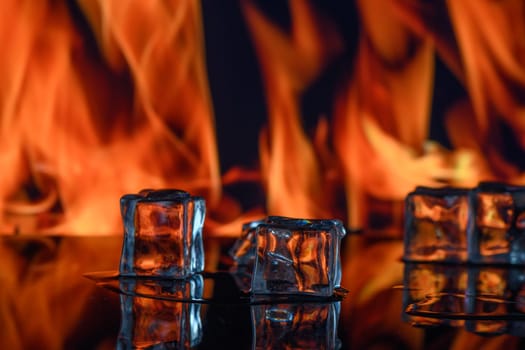 three ice cubes against the background of fire, fire and ice, place under the text 2