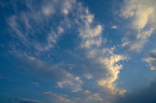 A view of pink clouds against a blue sky at sunset - stock photo 1