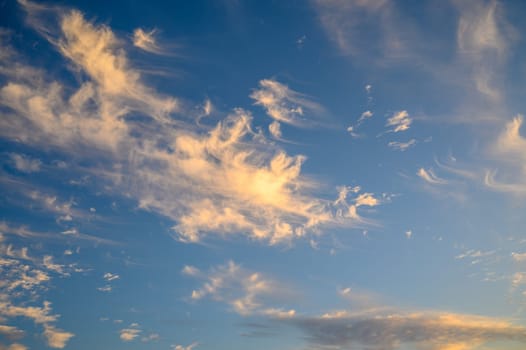 A view of pink clouds against a blue sky at sunset - stock photo 2