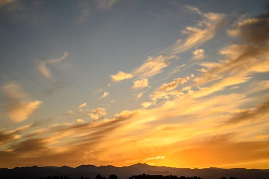 Colourful sunset sky. Full frame view of wispy colourful clouds up in the sky during sunrise or sunset hour