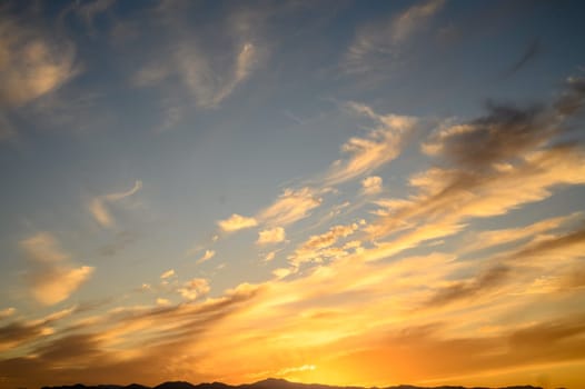 Colourful sunset sky. Full frame view of wispy colourful clouds up in the sky during sunrise or sunset hour 1