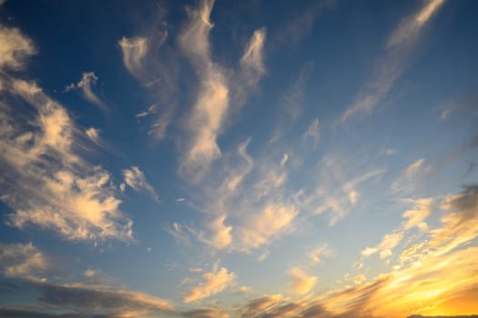 The gathering clouds during sunset create abstract painting patterns in the western sky.1