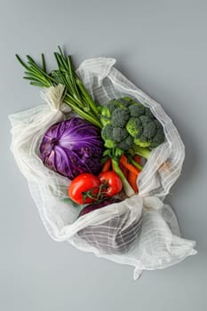 Assorted fresh vegetables in a plastic bag on a gray background, top view