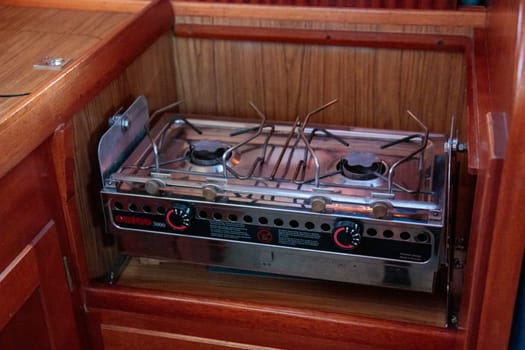 Cooking on the stainless stove on a sailing yacht in sailboat kitchen, sea life, old retro design