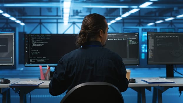 Engineer drinking coffee and programming in server room with equipment storing datasets. Employee enjoying caffeine beverage, typing code on PC to mend data center racks doing computational operations