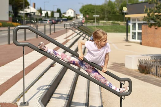 Girl doing gymnastics and splits in the city in France