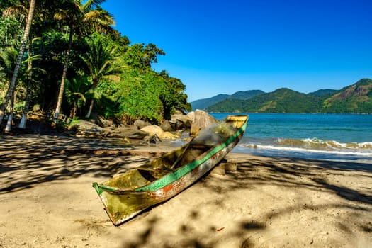 Fishing canoe over beach sand of Castelhanos beach in Ilhabela