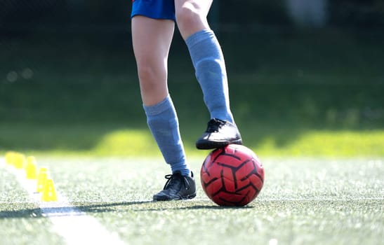 Girl Skillfully Dribbles Ball Between Flip Cups During Football Practice, Close-Up Shot