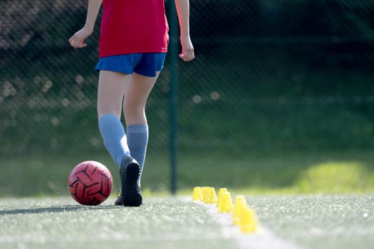 Girl Guides Ball Between Flip Cups At Football Practice, Close-Up View From Behind