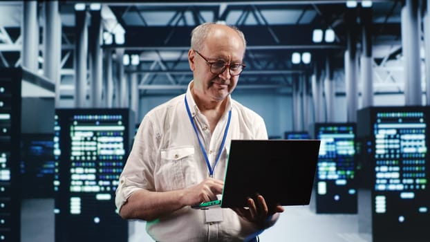 Overseeing supervisor expertly managing data while navigating in industrial server room. Skilled manager in high tech facility ensuring optimal cybersecurity protection, optimizing systems