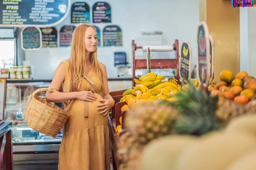 In a grocery store, a pregnant woman stands by a fruit stand, surrounded by various natural foods. She is in a public space where the local market offers whole foods for trade Pregnant woman buying organic vegetables and fruits at Mexican style farmers market