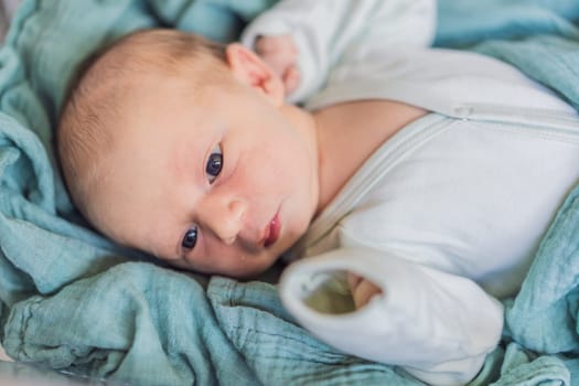 A newborn rests peacefully in his transparent bassinet in the hospital. The clear bassinet provides visibility for medical staff to monitor the baby's well-being while ensuring a safe and comfortable environment for the newborn.