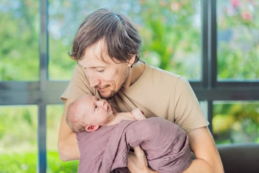 Dad and newborn at home. This tender moment captures the bond between father and child in a loving and comfortable family environment highlighting the joys of parenthood and the warmth of home.