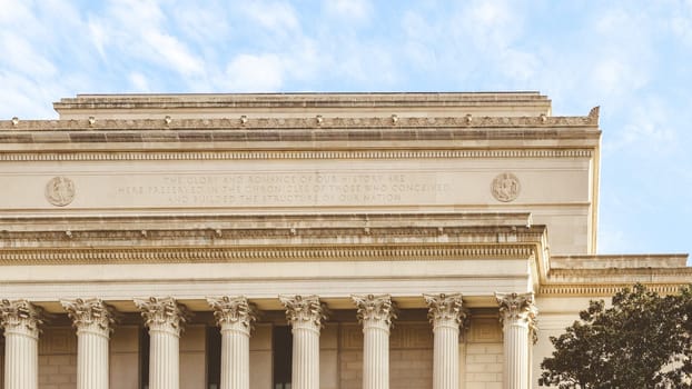 The grand government building features a row of columns, showcasing power and authority. Its design blends classical and neoclassical styles, symbolizing strength and stability.