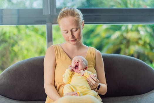 Mom with newborn baby relaxing on the sofa at home. This tender moment highlights the bond between mother and child in a comfortable and loving family environment.