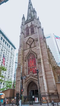 Iconic Trinity Church in Manhattan, New York City, showcases stunning Gothic Revival architecture blending history with modernity in the bustling cityscape, a captivating view.