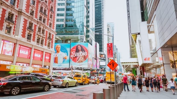 This lively city street captures the essence of a bustling metropolis, with a diverse crowd moving along the sidewalk as cars zip by the impressive backdrop of towering buildings.