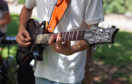 Boy plays country guitar. High quality photo