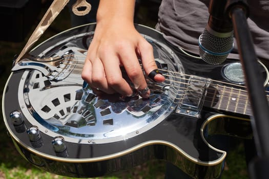 Boy plays country guitar. High quality photo