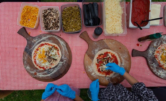 CHILDREN are preparing pizza. View from above. High quality photo