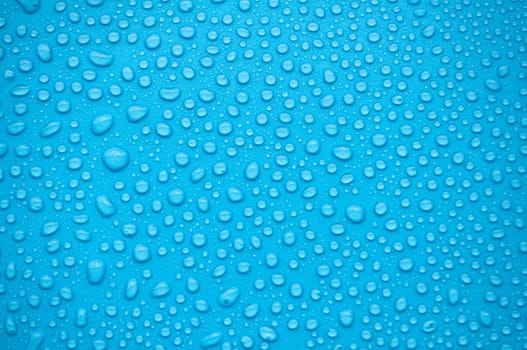 Close up of water droplets on blue background.