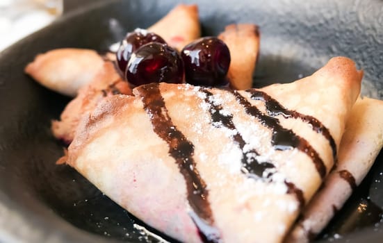 Sweet dessert, breakfast food and luxury service - French crepes with chocolate sauce and cherries in a reastaurant in Paris, pancakes recipe