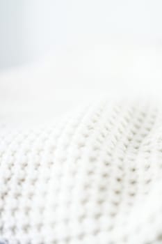 Knitwear, fabric textures and handmade items concept - Warm knitted clothes, soft and white