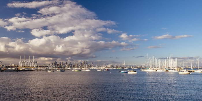 Melbourne skyline across Hobsons Bay from Ferguson St Pier in Williamstown waterfront at dusk in winter in Victoria, Australia