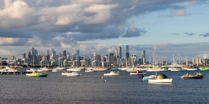 Melbourne skyline across Hobsons Bay from Ferguson St Pier in Williamstown waterfront at dusk in winter in Victoria, Australia