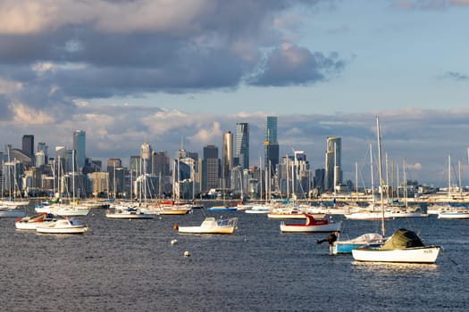 Melbourne skyline across Hobsons Bay from Ferguson St Pier in Williamstown waterfront at dusk in winter in Victoria, Australia