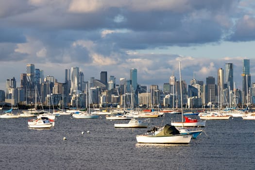 Melbourne skyline across Hobsons Bay from Ferguson St Pier in Williamstown waterfront at dusk in winter in Victoria, Australia