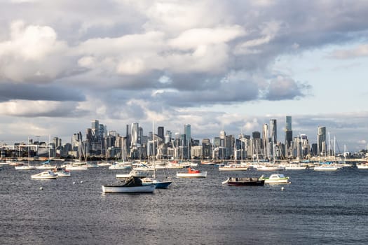 Melbourne skyline across Hobsons Bay from Ferguson St Pier in Williamstown waterfront at dusk in winter in Victoria, Australia