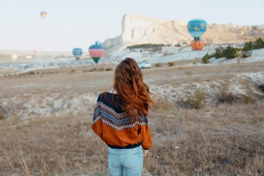 Spectacular view of colorful hot air balloons floating above the scenic landscape of cappadocia, turkey