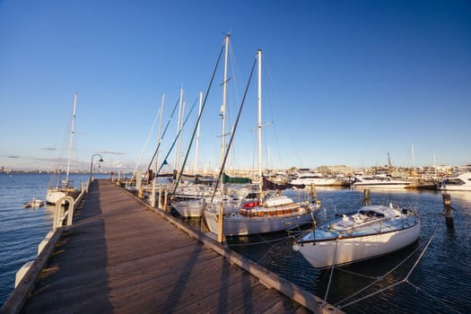 Hobsons Bay around Ferguson St Pier in Williamstown waterfront at dusk in winter in Victoria, Australia
