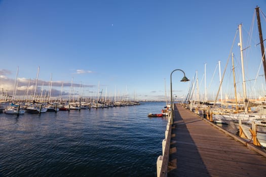 Hobsons Bay around Ferguson St Pier in Williamstown waterfront at dusk in winter in Victoria, Australia