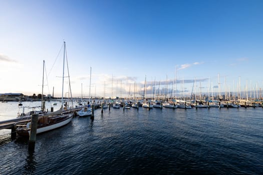 Melbourne skyline across Hobsons Bay from Ferguson St Pier in Williamstown waterfront at dusk in winter in Victoria, Australia