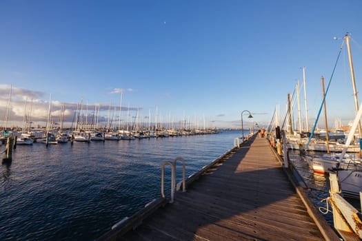Hobsons Bay around Ferguson St Pier in Williamstown waterfront at dusk in winter in Victoria, Australia