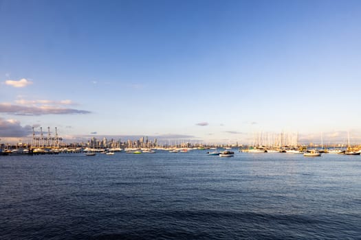 Melbourne skyline across Hobsons Bay from Ferguson St Pier in Williamstown waterfront at dusk in winter in Victoria, Australia